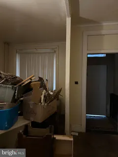 a room with water heater and wooden closet