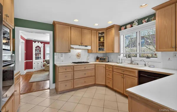 a kitchen with a sink window and cabinets