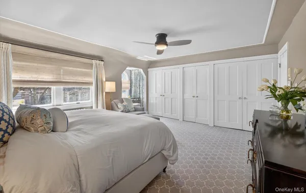 a bedroom with a large bed and a chandelier