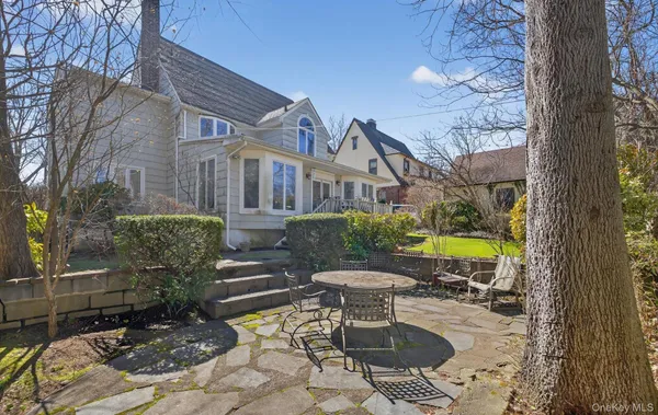 a view of a swimming pool with chairs and potted plants