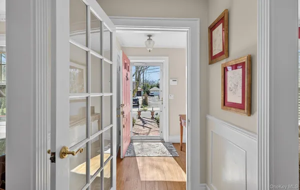 a view of a hallway with wooden floor and entryway