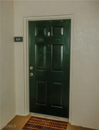 an empty room with windows and entrance