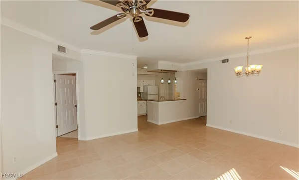 a kitchen with a sink a stove a refrigerator and white cabinets