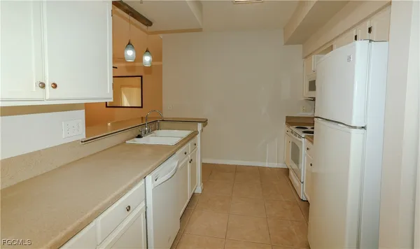 a kitchen with cabinets a sink and a stove