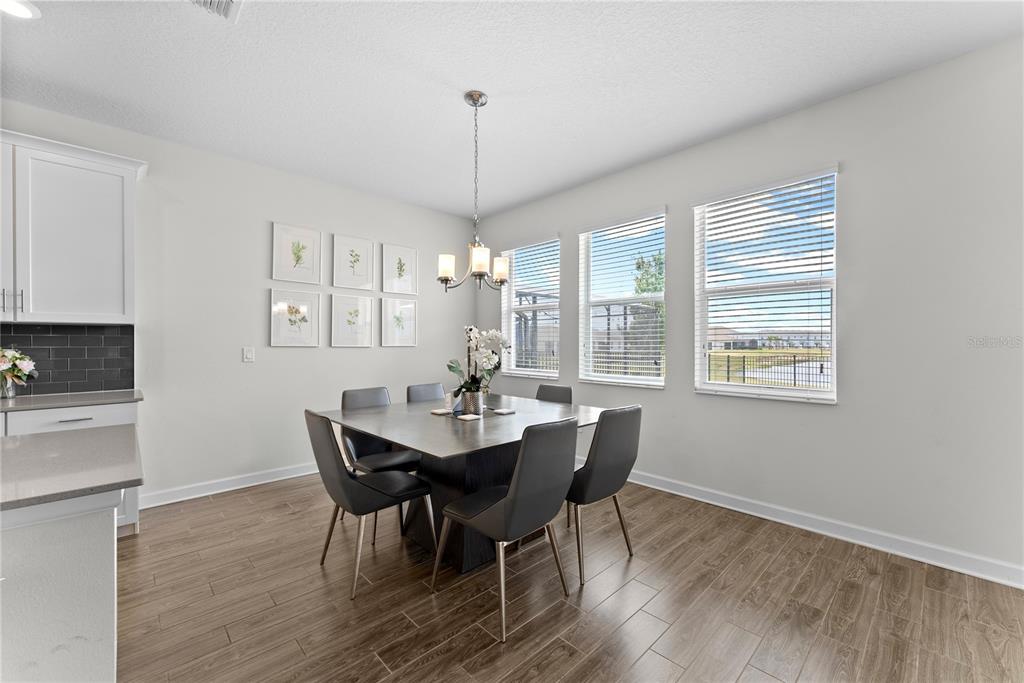 2926 Wordsmith Road Kissimmee, FL 34746 - Photo 23 of 42 a view of a dining room with furniture window and wooden floor