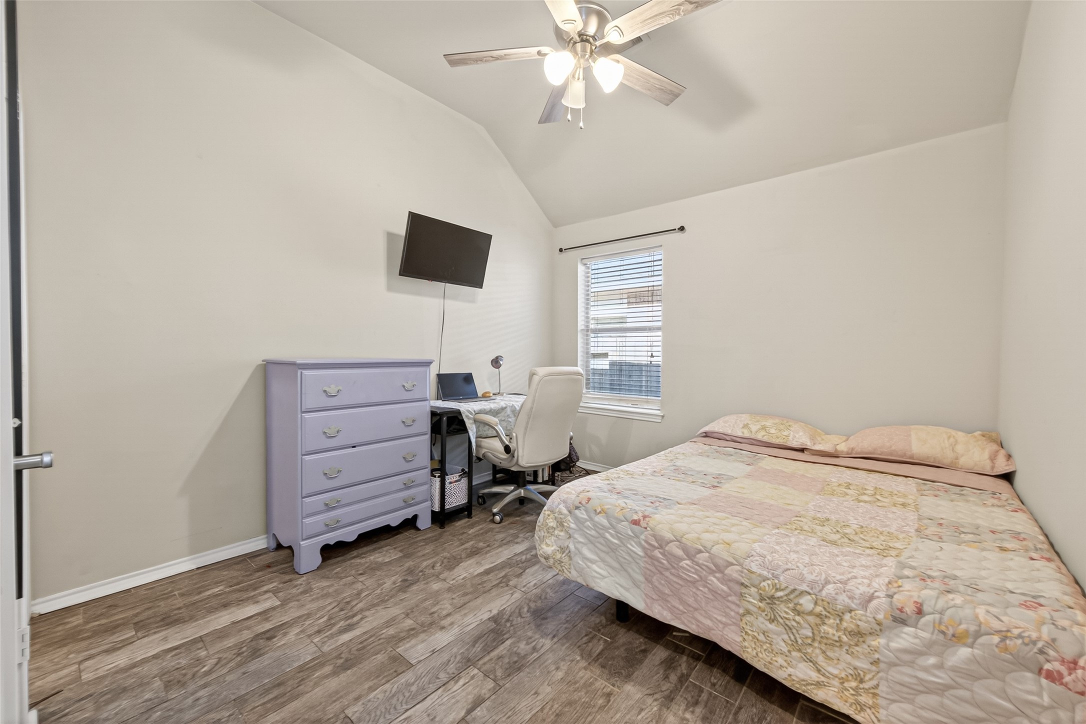 27443 Rebecca Field Lane Spring, TX 77386 - Photo 20 of 31 Bedroom 2 - This cozy bedroom features a vaulted ceiling, ceiling fan, natural light from a window and a walk-in closet!