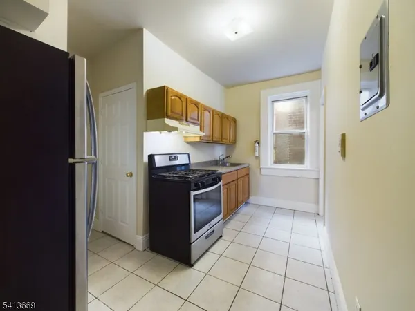 a kitchen with stainless steel appliances granite countertop a stove a refrigerator and a sink