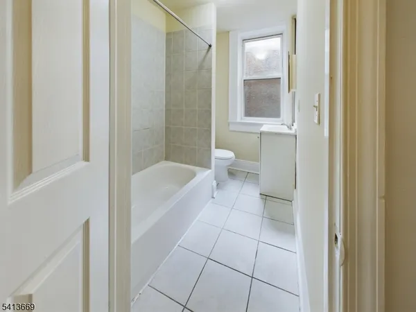 a bathroom with a bathtub and toilet