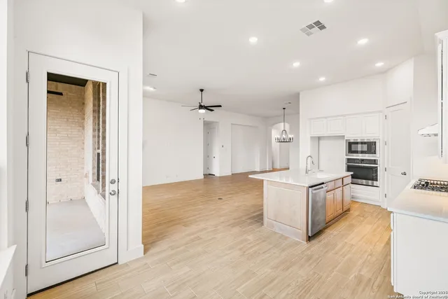 a view of kitchen with sink and refrigerator