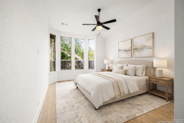 a bedroom with a large bed and a window