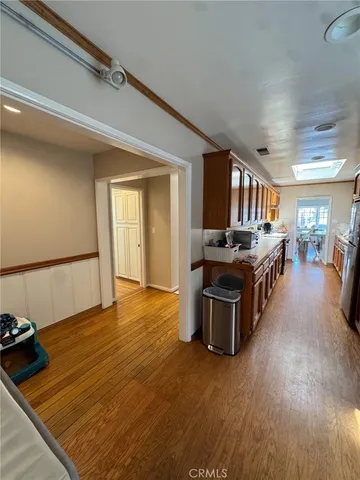 a kitchen with stainless steel appliances granite countertop a stove and a wooden floors