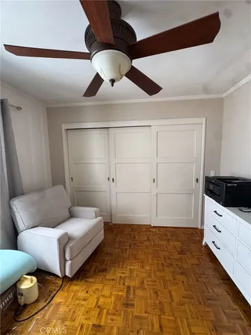 a spacious bedroom with a bed and ceiling fan