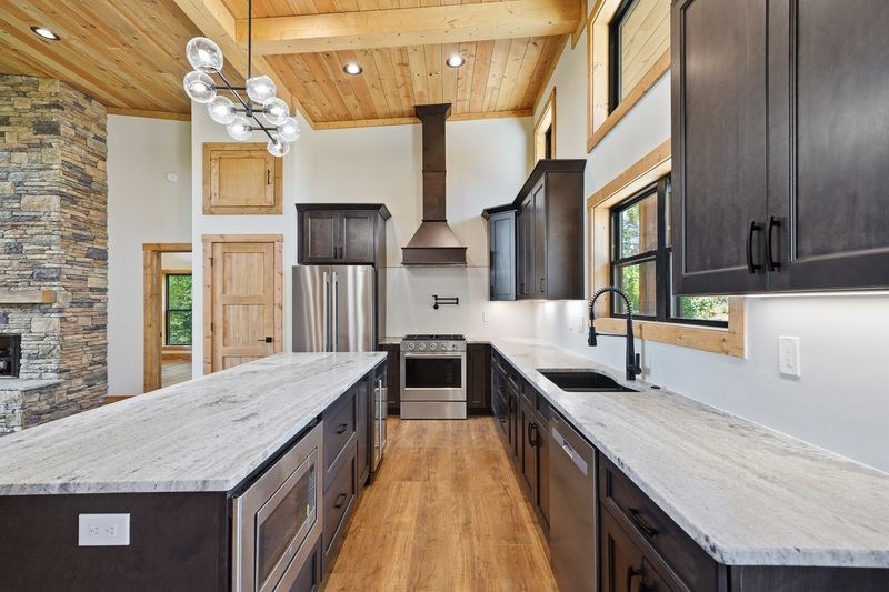 216 Old Orchard Road Ellijay, GA 30536 - Photo 4 of 59 a kitchen with stainless steel appliances granite countertop a kitchen island a stove a sink dishwasher and cabinets with wooden floor