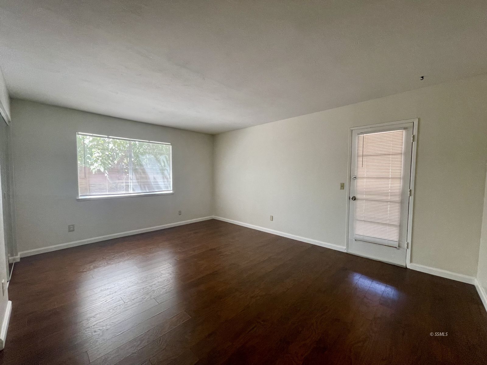 225 East Rader Avenue Ridgecrest, CA 93555 - Photo 20 of 30 an empty room with wooden floor cabinet and windows