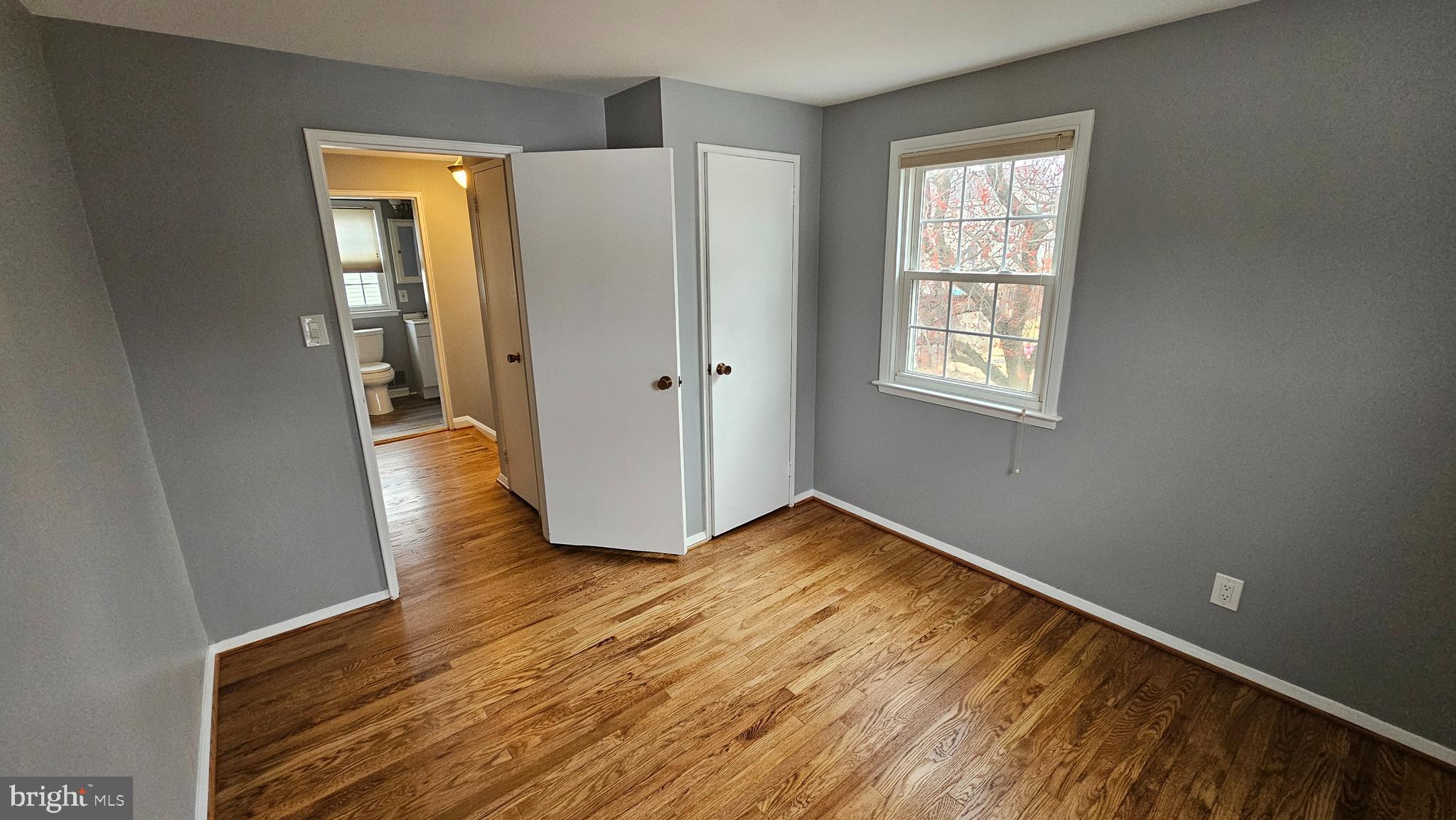 321 Ardmore Road Linthicum Heights, MD 21090 - Photo 19 of 24 a view of an empty room with wooden floor and a window