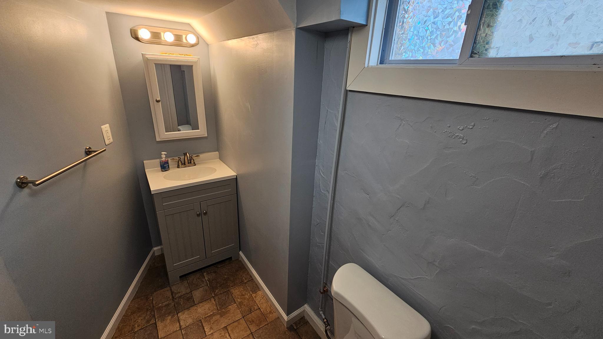 321 Ardmore Road Linthicum Heights, MD 21090 - Photo 23 of 24 a bathroom with a toilet sink and mirror