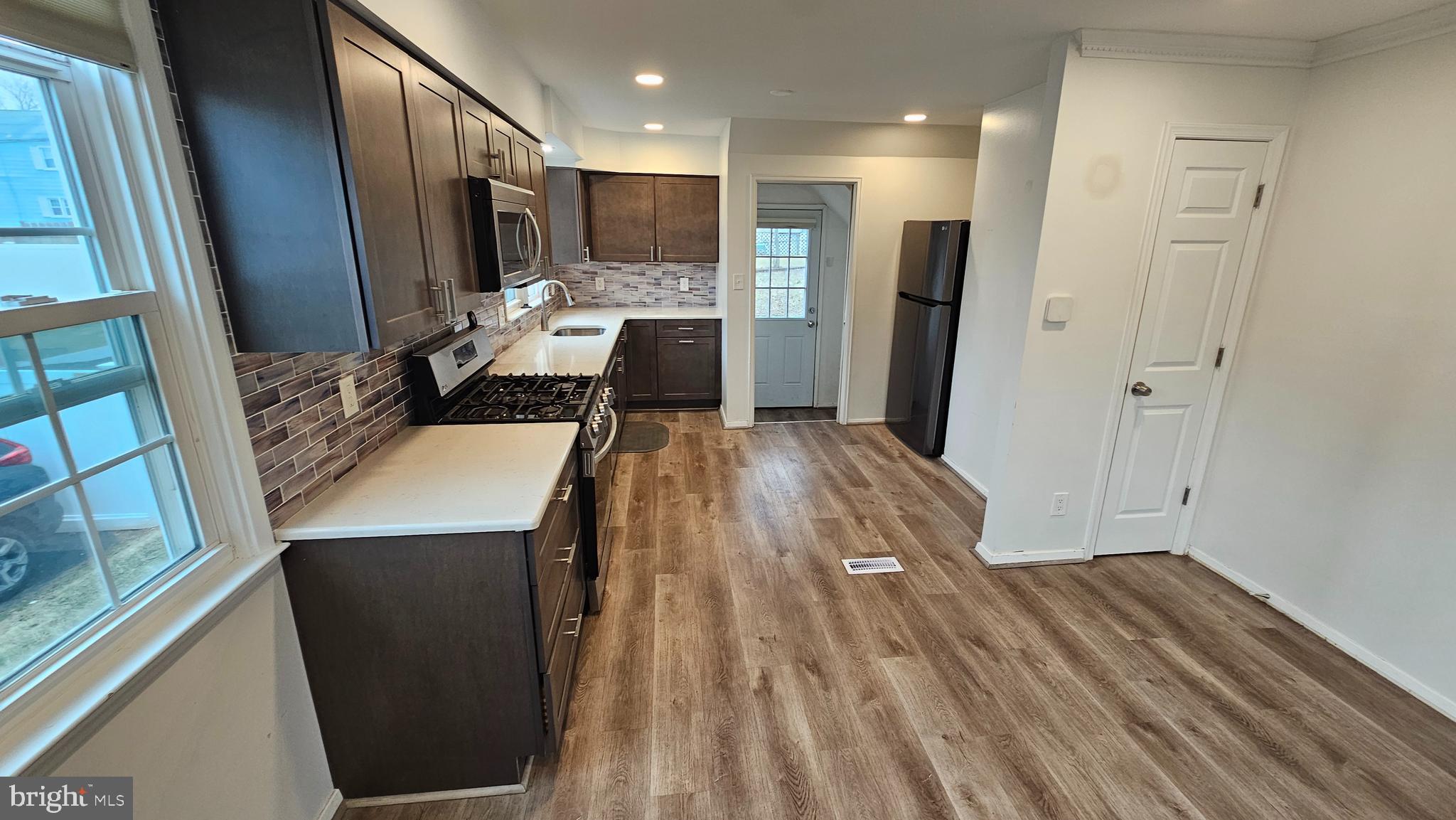 321 Ardmore Road Linthicum Heights, MD 21090 - Photo 7 of 24 a view of kitchen with refrigerator stove and wooden floor