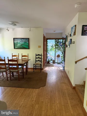 a living room with furniture wooden floor and a large window