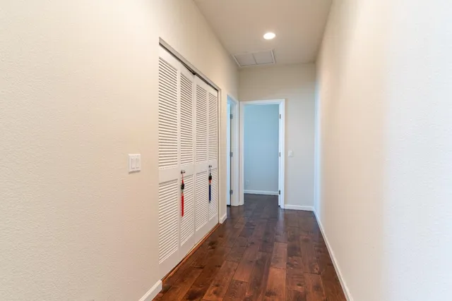 a view of a hallway with wooden floor