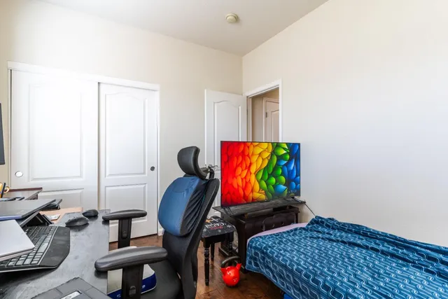 a bedroom with furniture and a wooden floor