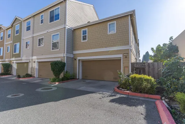 a front view of a house with a yard and a garage