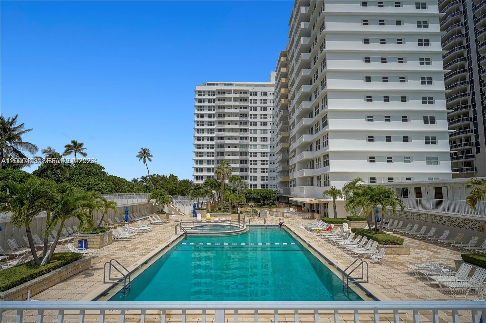 4747 Collins Avenue, Unit 1108 Miami Beach, FL 33140 - Photo 12 of 17 a view of a swimming pool with outdoor seating