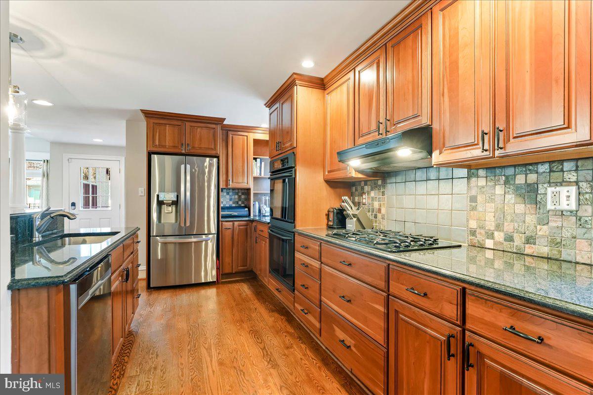 132 North Highland Road Springfield, PA 19064 - Photo 11 of 35 a kitchen with stainless steel appliances granite countertop a refrigerator a sink and a stove