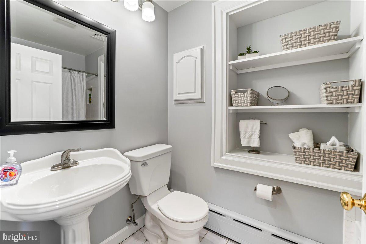 132 North Highland Road Springfield, PA 19064 - Photo 23 of 35 a bathroom with a sink a toilet and a mirror