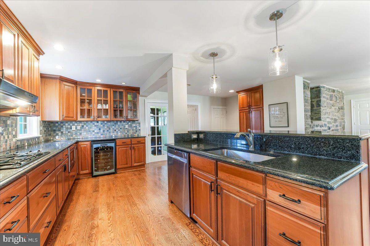 132 North Highland Road Springfield, PA 19064 - Photo 10 of 35 a kitchen with stainless steel appliances granite countertop a sink a stove and a wooden floors