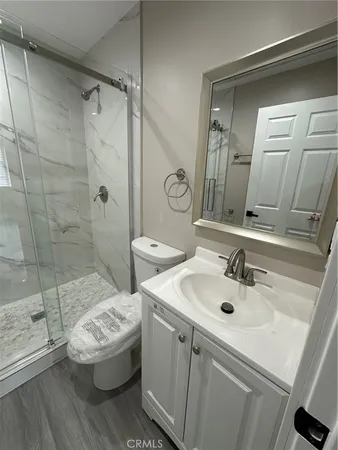 a kitchen with a refrigerator a stove top oven and wooden floor