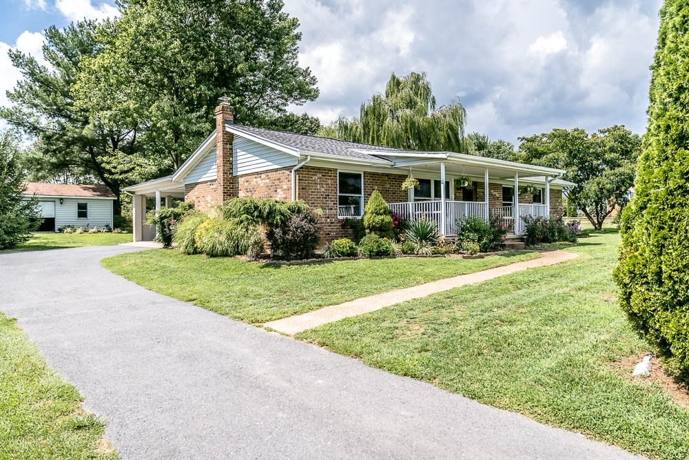 7812 Windy Cove Road Bridgewater, VA 22812 - Photo 1 of 41 a view of house in front of a big yard with potted plants