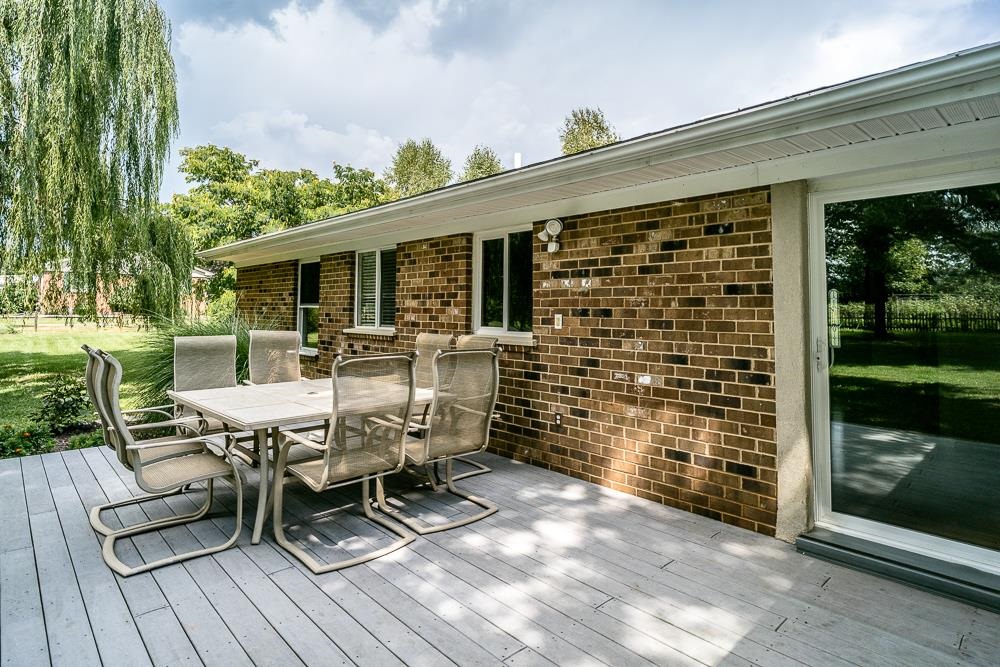 7812 Windy Cove Road Bridgewater, VA 22812 - Photo 24 of 41 a view of a patio with table and chairs with wooden floor and fence