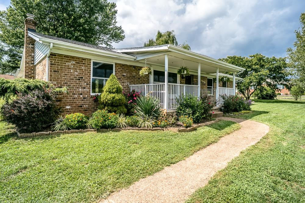7812 Windy Cove Road Bridgewater, VA 22812 - Photo 26 of 41 a front view of a house with a yard and potted plants