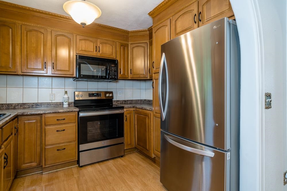 7812 Windy Cove Road Bridgewater, VA 22812 - Photo 6 of 41 a kitchen with stainless steel appliances granite countertop a refrigerator stove and sink