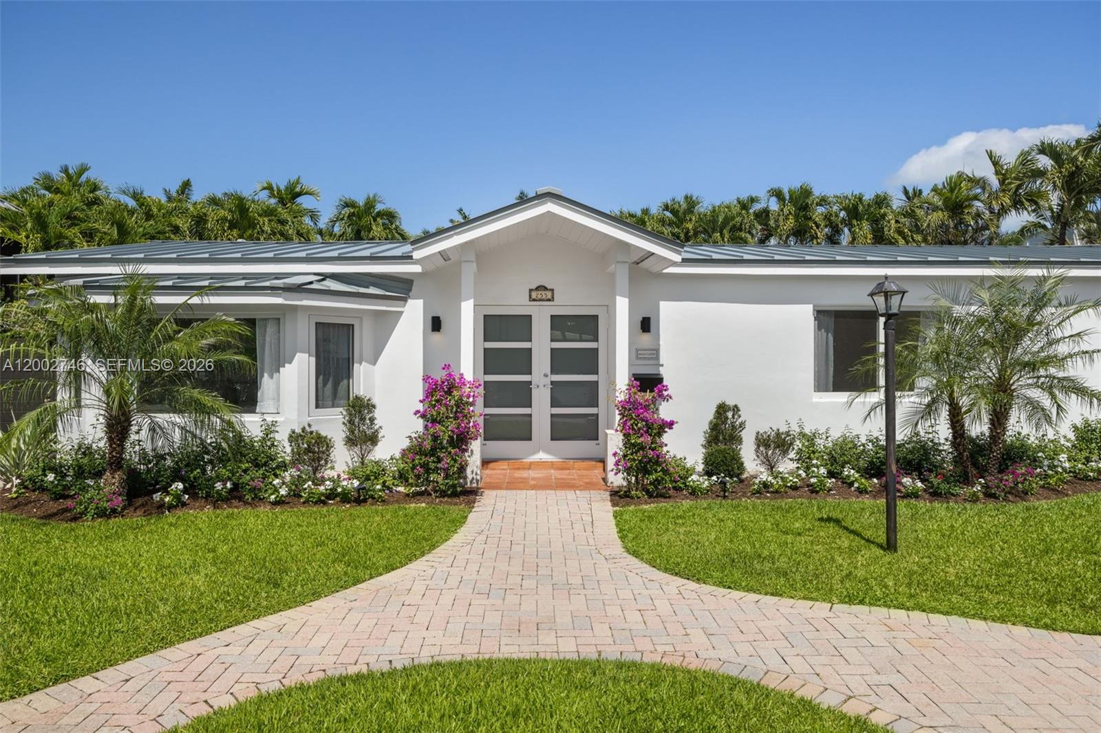 255 Ridgewood Road Key Biscayne, FL 33149 - Photo 1 of 30 front view of a house with a yard