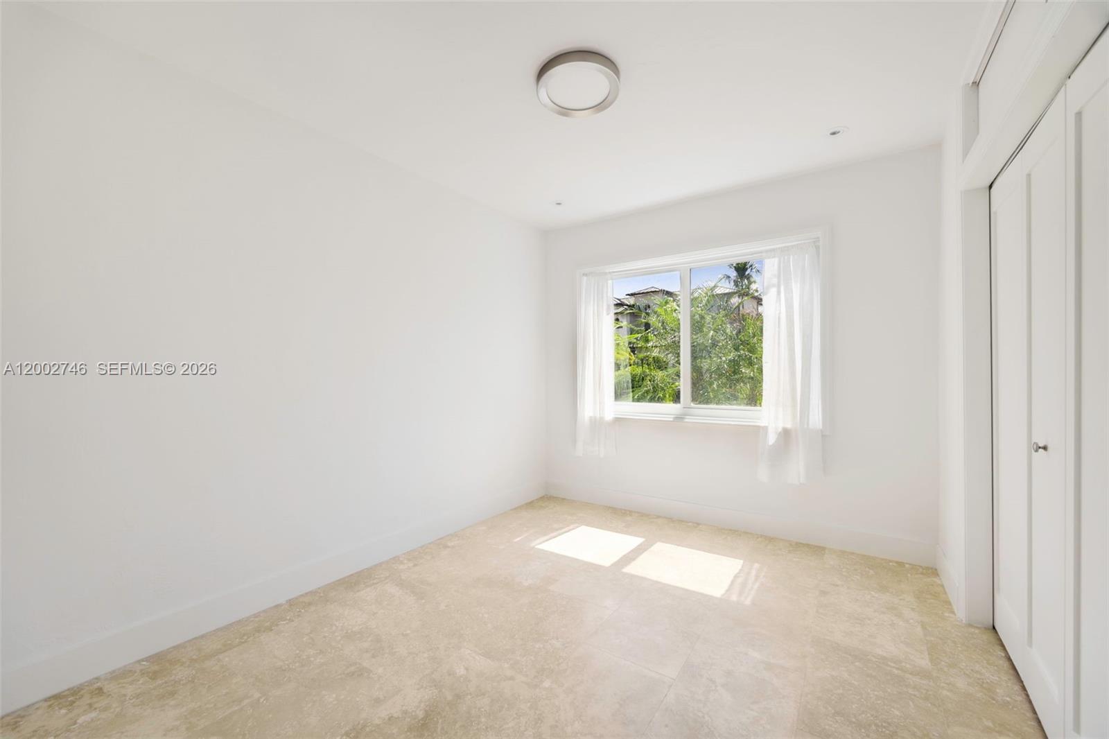 255 Ridgewood Road Key Biscayne, FL 33149 - Photo 13 of 30 an empty room with a window