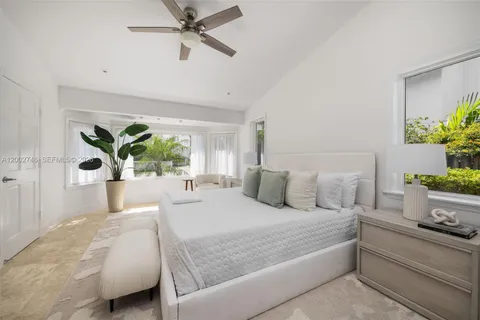 a bedroom with a large bed and potted plant