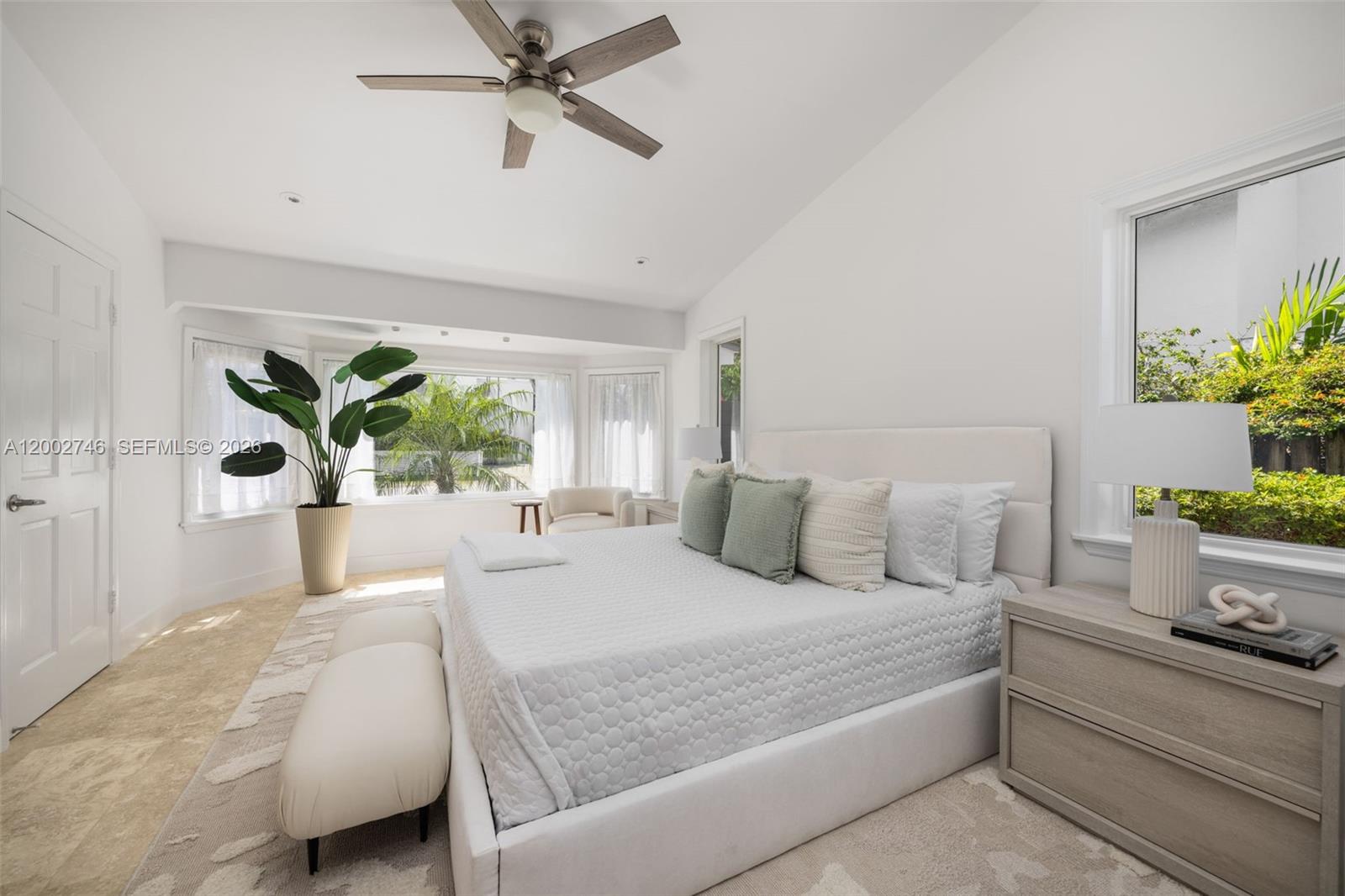 255 Ridgewood Road Key Biscayne, FL 33149 - Photo 16 of 30 a bedroom with a large bed and potted plant