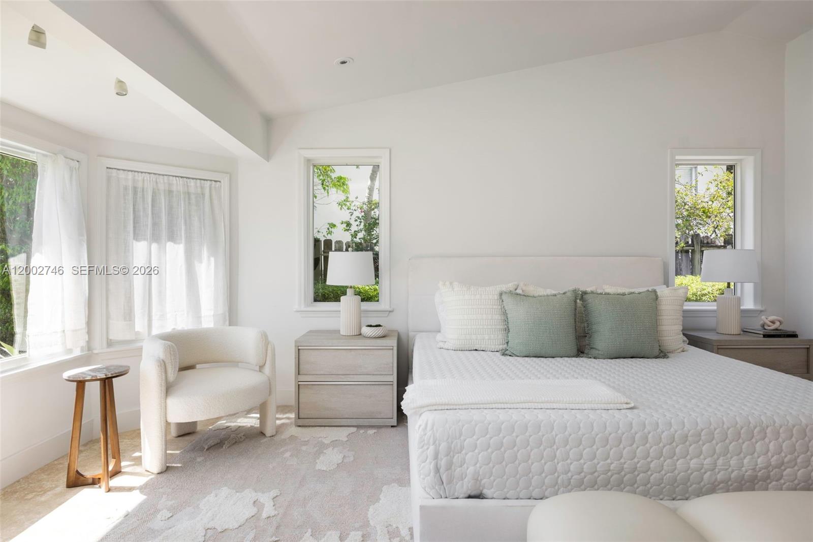 255 Ridgewood Road Key Biscayne, FL 33149 - Photo 17 of 30 a bedroom with a bed and a couch next to a window