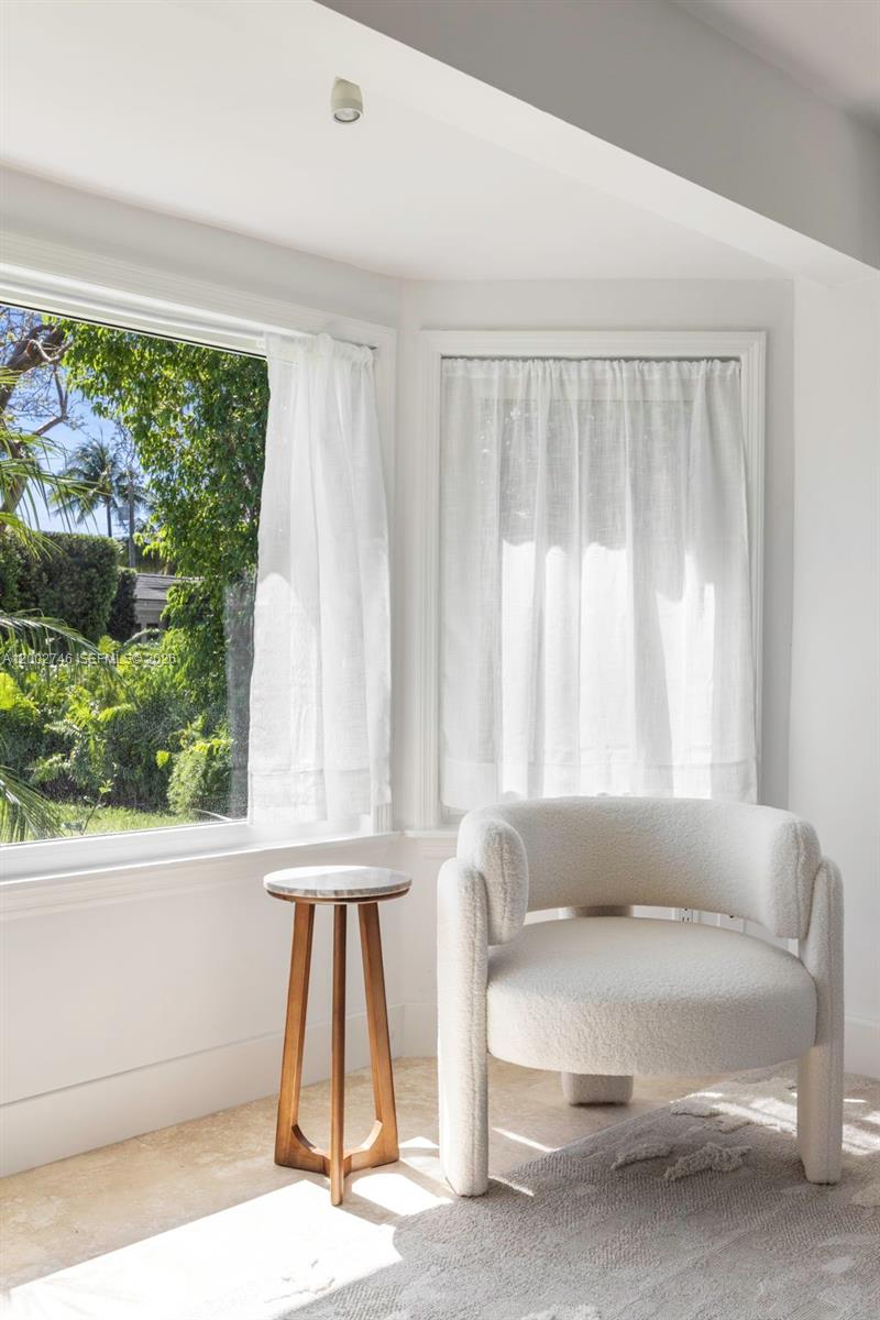 255 Ridgewood Road Key Biscayne, FL 33149 - Photo 18 of 30 a living room with a large window and a table