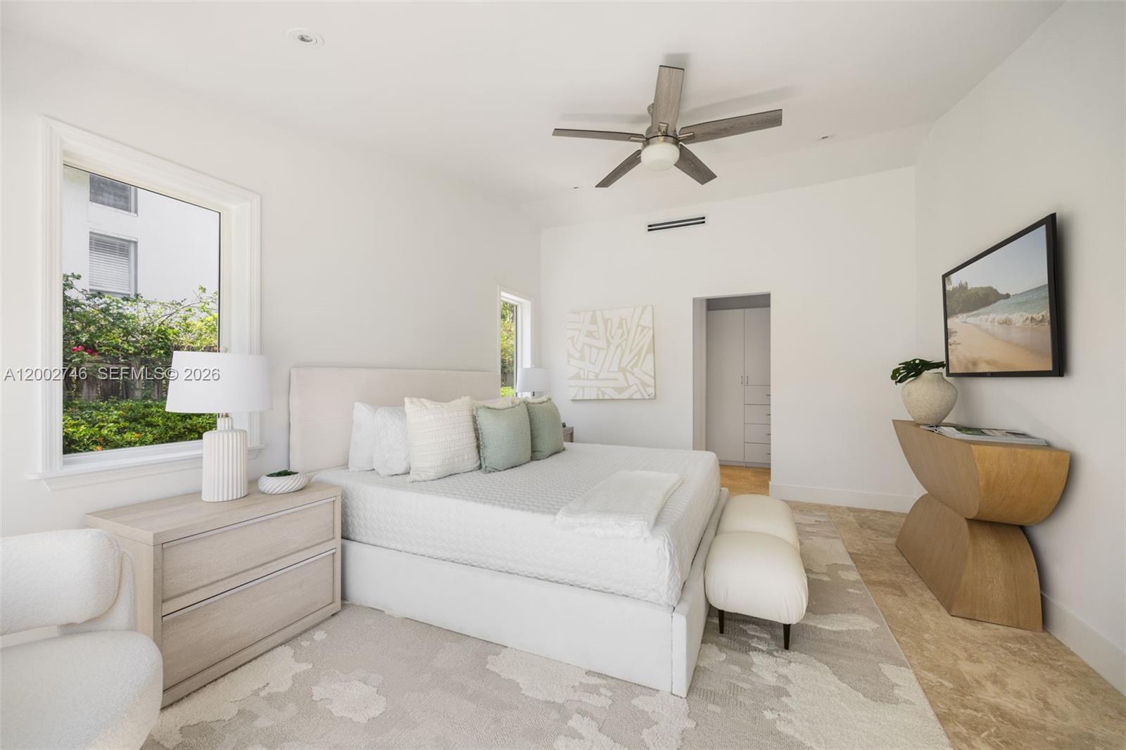255 Ridgewood Road Key Biscayne, FL 33149 - Photo 19 of 30 a spacious bedroom with a bed and a window