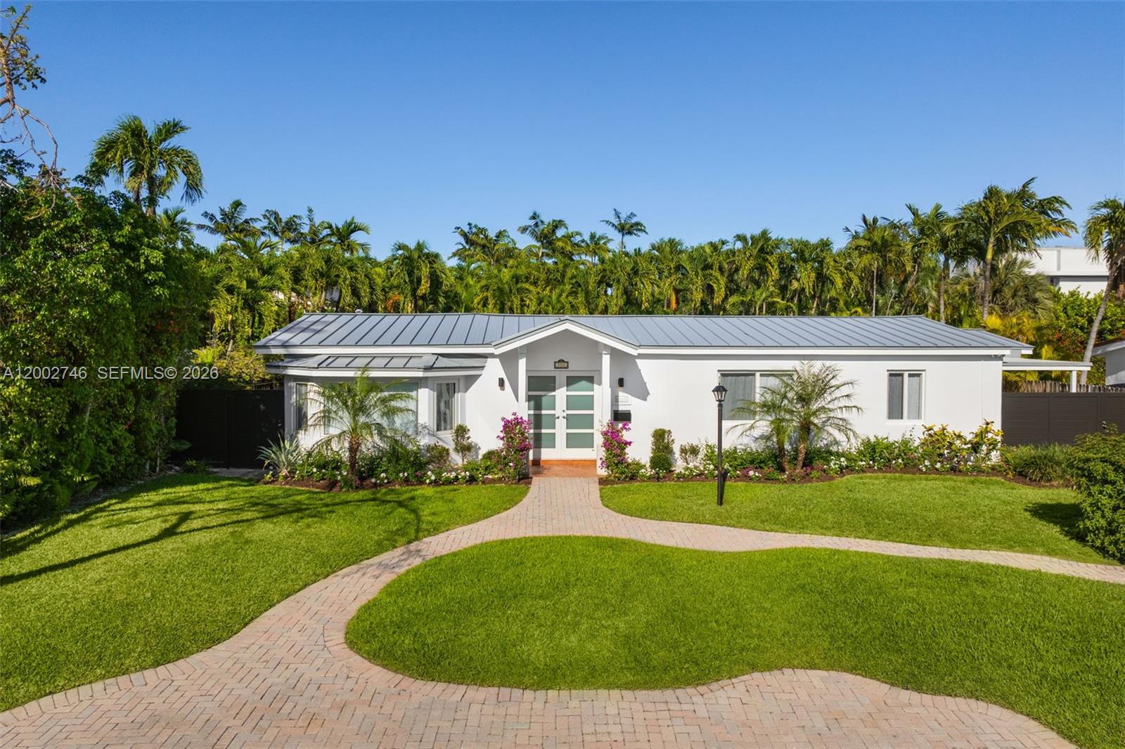 255 Ridgewood Road Key Biscayne, FL 33149 - Photo 2 of 30 a view of a house with garden and a trees