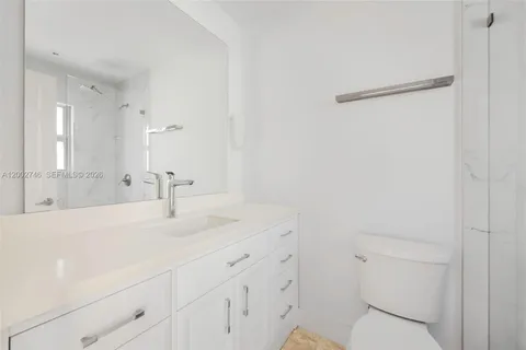 a bathroom with a sink a toilet and a mirror