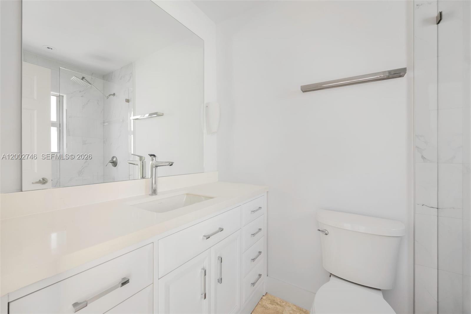 255 Ridgewood Road Key Biscayne, FL 33149 - Photo 21 of 30 a bathroom with a sink a toilet and a mirror