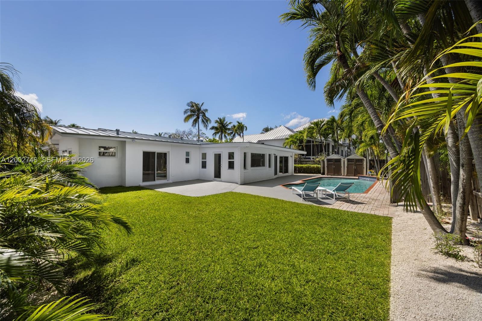 255 Ridgewood Road Key Biscayne, FL 33149 - Photo 26 of 30 a view of a house with backyard and sitting area