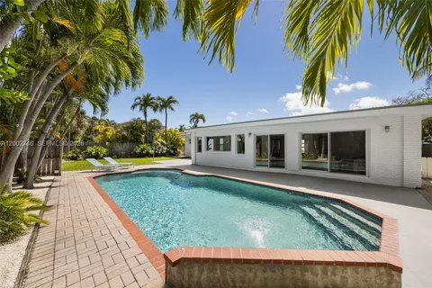 swimming pool view with a seating space