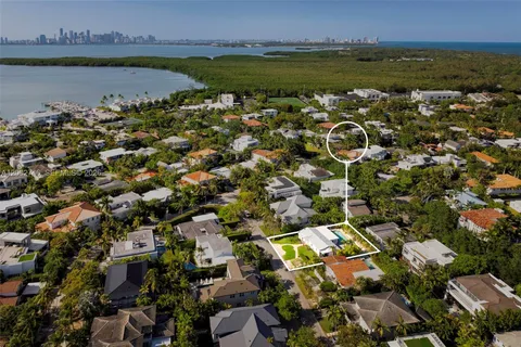 an aerial view of a houses with a lake view