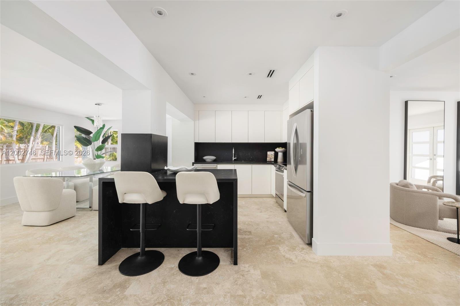 255 Ridgewood Road Key Biscayne, FL 33149 - Photo 6 of 30 a living room with furniture a dining table and chairs