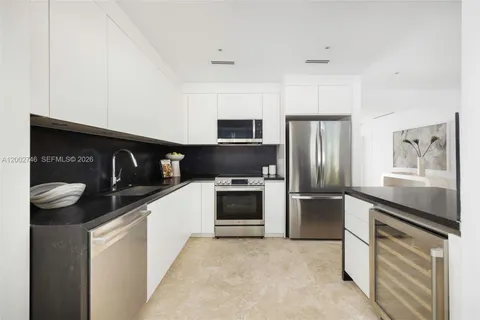 a kitchen with stainless steel appliances kitchen island granite countertop a stove and a refrigerator