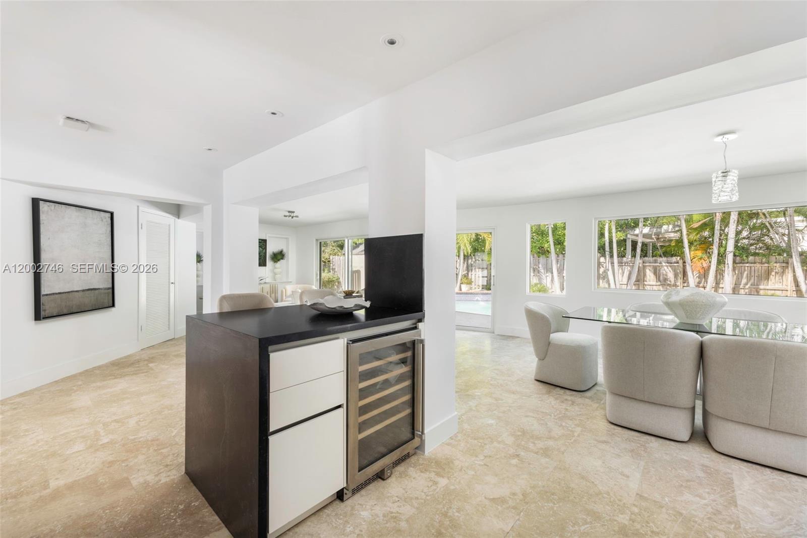 255 Ridgewood Road Key Biscayne, FL 33149 - Photo 8 of 30 a kitchen with stainless steel appliances granite countertop a sink and a refrigerator